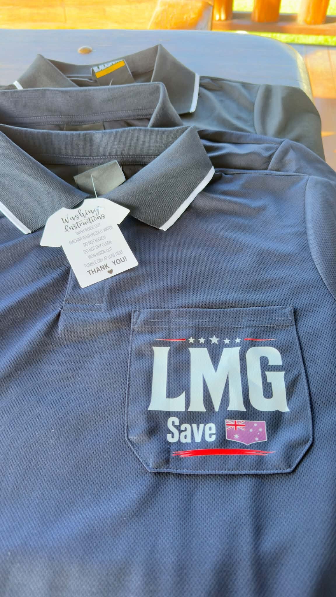 LMG collared shirt — chest pocket with LMG Save Australia logo and care label detail